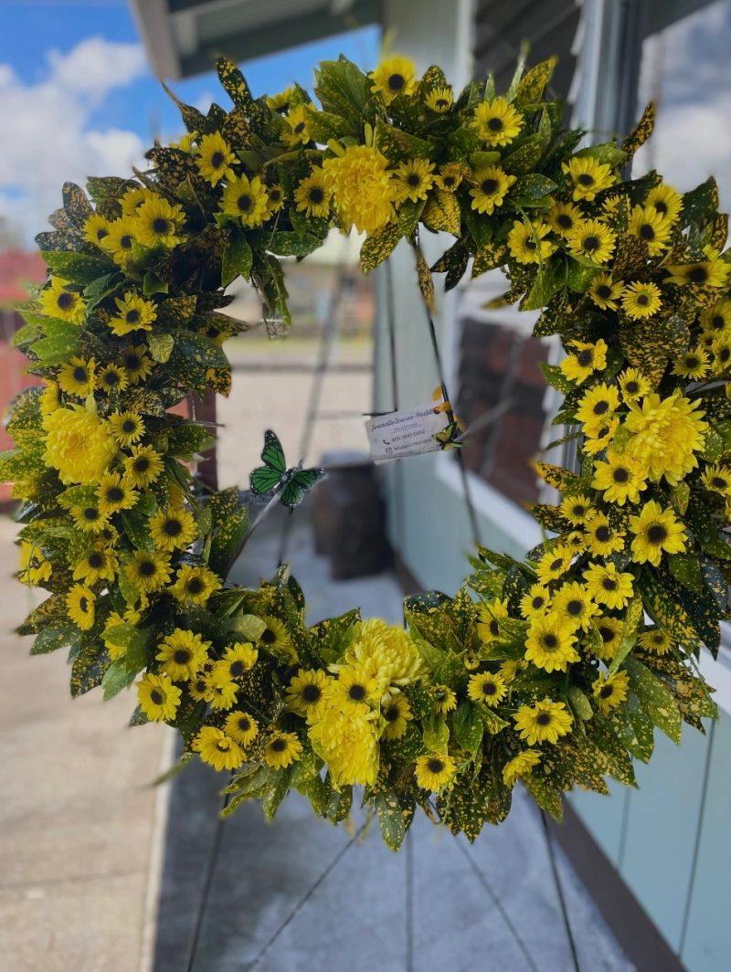 Circular sunflower wreath with green foliage